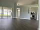 Open-concept living area with sliding glass doors, hardwood flooring, and neutral paint at 8414 Sw 136Th Pl, Ocala, FL 34473