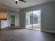 Open living space featuring wood-look floors and large sliding glass doors to the screened in patio at 8414 Sw 136Th Pl, Ocala, FL 34473