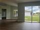Bright living room with hardwood floors, sliding glass doors to the backyard, and open floor plan at 8414 Sw 136Th Pl, Ocala, FL 34473