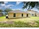 A cozy home featuring a well-maintained backyard with a sliding glass door for seamless indoor-outdoor living at 85 Levee Ln, Ormond Beach, FL 32174