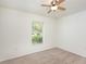 Cozy bedroom with soft carpet, large window with blinds, and a ceiling fan at 85 Levee Ln, Ormond Beach, FL 32174