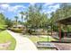 Enjoy a refreshing community pool with lush landscaping, shaded picnic area, and convenient walkway at 85 Levee Ln, Ormond Beach, FL 32174