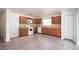 Well-lit kitchen with wooden cabinets, tile backsplash, updated appliances, and laminate wood flooring at 85 Levee Ln, Ormond Beach, FL 32174