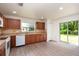 Well-lit kitchen with wood-look flooring and a sliding door to the yard at 85 Levee Ln, Ormond Beach, FL 32174