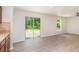Spacious living area with sliding glass doors leading to the backyard, next to the kitchen at 85 Levee Ln, Ormond Beach, FL 32174