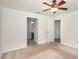 Neutral main bedroom with a ceiling fan, ensuite bath, and ample closet space at 85 Levee Ln, Ormond Beach, FL 32174