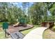Fun community playground area for with play structure, mulch ground cover, and sidewalk access at 85 Levee Ln, Ormond Beach, FL 32174