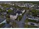 Aerial view of a well-maintained neighborhood featuring mature trees and sidewalks near a house at 8665 Pinter St, Orlando, FL 32827