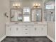 A bathroom featuring marble countertops with double sinks, bronze hardware and decorative lighting at 8665 Pinter St, Orlando, FL 32827
