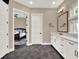 A view into the main bedroom from the bathroom with marble countertops and bronze hardware at 8665 Pinter St, Orlando, FL 32827