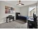 Well-lit bedroom with posters, a piano, and a study desk, creating a functional and stylish space at 8665 Pinter St, Orlando, FL 32827