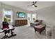 This is a bonus room with large windows, a ceiling fan, and comfortable seating, creating a welcoming atmosphere at 8665 Pinter St, Orlando, FL 32827