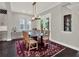 Bright dining room featuring a glass-top table, decorative rug, and a stylish modern chandelier at 8665 Pinter St, Orlando, FL 32827