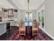 Bright dining room adjacent to the kitchen features a glass-top table and decorative rug at 8665 Pinter St, Orlando, FL 32827