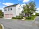 Charming two-story home with a white exterior and a pink garage door at 8665 Pinter St, Orlando, FL 32827