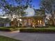 Charming two-story home with a welcoming front porch, stone columns, and manicured landscaping at 8665 Pinter St, Orlando, FL 32827