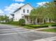 Charming two-story home boasts a welcoming front porch with brick accents and a meticulously landscaped yard at 8665 Pinter St, Orlando, FL 32827