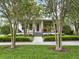 Charming two-story home with a manicured lawn, lush landscaping, and a welcoming front porch at 8665 Pinter St, Orlando, FL 32827