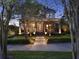 Inviting two-story home with a charming front porch, attractive stone columns, and well-maintained landscaping at 8665 Pinter St, Orlando, FL 32827