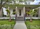 Close up of a charming front porch with stylish stone columns, and manicured landscaping at 8665 Pinter St, Orlando, FL 32827