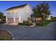 Charming two-story home with a white exterior and a pink garage door at dusk at 8665 Pinter St, Orlando, FL 32827