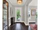 Elegant foyer with dark hardwood floors, stylish decor, and a view of the front yard at 8665 Pinter St, Orlando, FL 32827