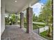View of a covered front porch with brick pillars looking out at the street at 8665 Pinter St, Orlando, FL 32827