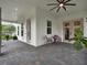View of a covered front porch with a seating area and multiple windows at 8665 Pinter St, Orlando, FL 32827