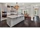 Open concept kitchen with center island, breakfast nook, stainless appliances, and designer lighting at 8665 Pinter St, Orlando, FL 32827