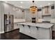 Modern kitchen with stainless steel appliances, a large island, pendant lighting, and wine storage at 8665 Pinter St, Orlando, FL 32827