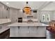 Bright kitchen featuring a large island, pendant lighting, modern appliances, and wine rack at 8665 Pinter St, Orlando, FL 32827