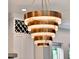 Modern chandelier featuring gold and marble accents above kitchen area and cabinets at 8665 Pinter St, Orlando, FL 32827