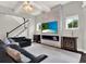 Open living room showcasing a modern fireplace, a large TV, and a staircase at 8665 Pinter St, Orlando, FL 32827