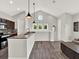 Open living space with gray floors, a kitchen island, and bright lighting at 8665 Pinter St, Orlando, FL 32827