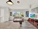 Comfortable living room with gray floors, a plush sofa, a decorative rug, and abundant natural light at 8665 Pinter St, Orlando, FL 32827