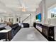 Open-concept living room with modern fireplace, staircase, and sleek black leather sofa at 8665 Pinter St, Orlando, FL 32827