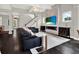 Bright living room featuring a modern fireplace, staircase, and stylish decor at 8665 Pinter St, Orlando, FL 32827