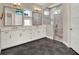 A main bathroom featuring a walk-in shower and double sinks with bronze hardware at 8665 Pinter St, Orlando, FL 32827