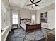 A relaxing main bedroom featuring a wooden framed bed and decorative blue rug at 8665 Pinter St, Orlando, FL 32827