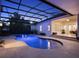 View of the screened pool with spa and covered lanai at 8665 Pinter St, Orlando, FL 32827