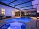 A beautiful screened pool with spa and travertine pavers at 8665 Pinter St, Orlando, FL 32827