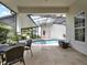 Beautiful pool and patio area with travertine tiles and views of a manicured backyard at 8665 Pinter St, Orlando, FL 32827