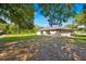 The backyard features mature trees and sunny areas at 910 Amy Ridge Ct, Kissimmee, FL 34747