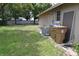 Backyard with grassy lawn, exterior utilities, and partial wall for privacy at 910 Amy Ridge Ct, Kissimmee, FL 34747