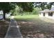 Wide backyard with grass and a walkway leading to the back of the house at 910 Amy Ridge Ct, Kissimmee, FL 34747