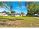 View of backyard and exterior of home under a blue sky at 910 Amy Ridge Ct, Kissimmee, FL 34747