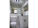Bathroom featuring updated vanity, toilet and modern mirror at 910 Amy Ridge Ct, Kissimmee, FL 34747