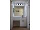 Bathroom vanity featuring a large mirror, modern lighting, and white cabinetry at 910 Amy Ridge Ct, Kissimmee, FL 34747