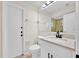 Bathroom with white vanity, black hardware, and tile flooring at 910 Amy Ridge Ct, Kissimmee, FL 34747