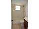 Bathroom with tiled walls, shower-tub, and window for natural light at 910 Amy Ridge Ct, Kissimmee, FL 34747